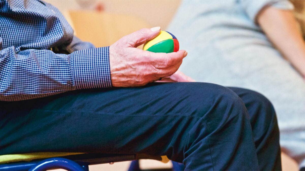 Man holding therapeutic ball