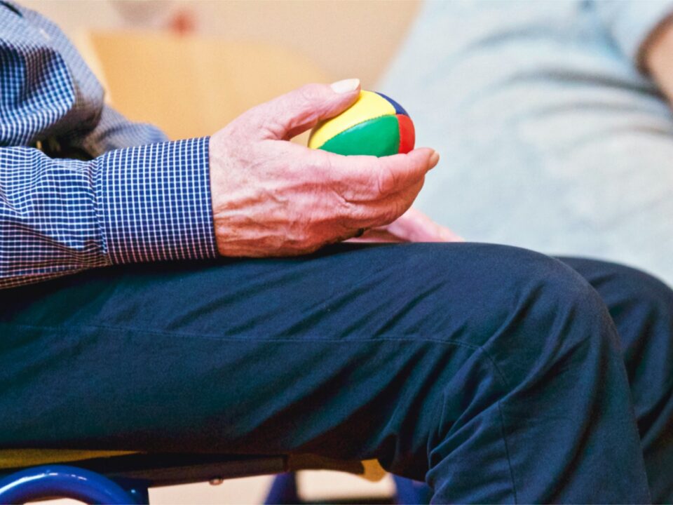 Man holding therapeutic ball