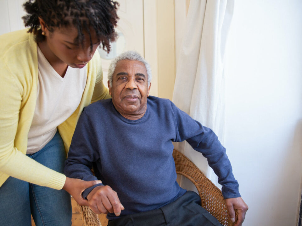 Nurse assisting elderly man