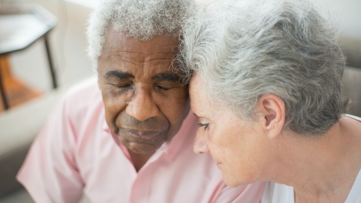Elderly couple with their heads touching