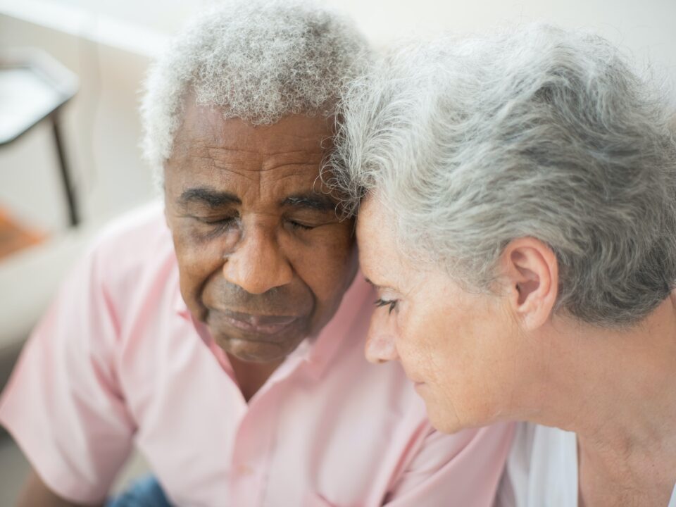 Elderly couple with their heads touching