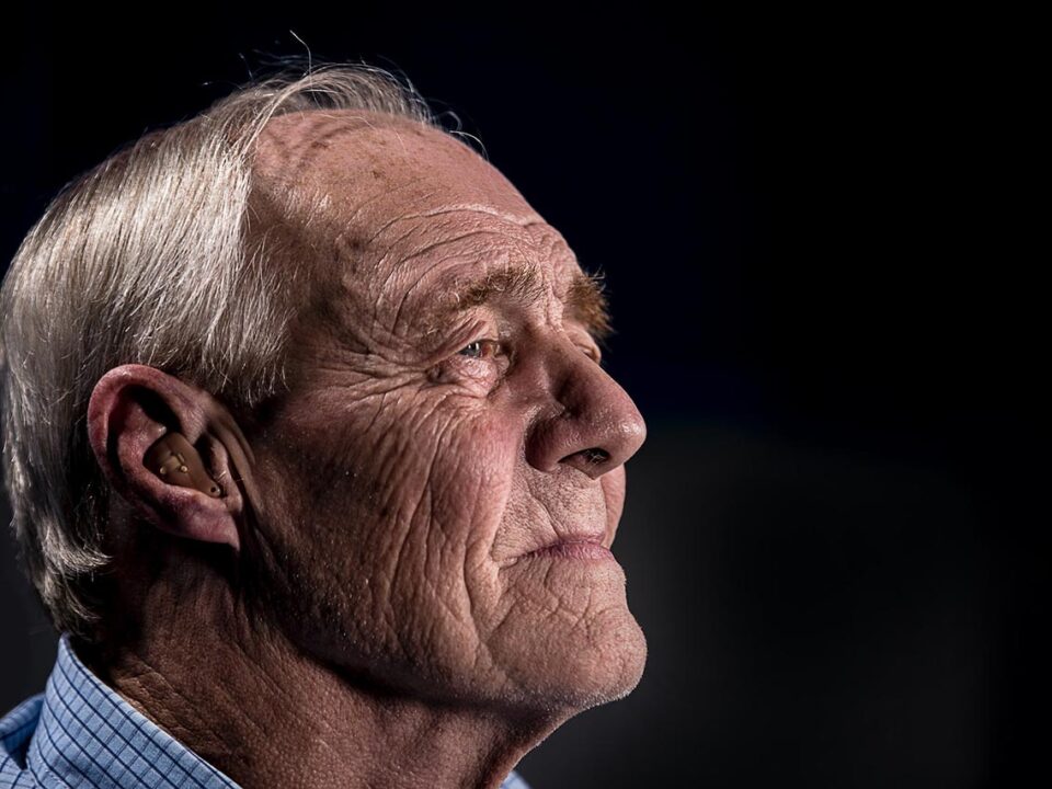 Elderly man with earpiece