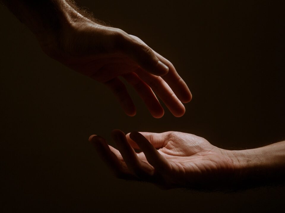 Two hands reaching out to each other